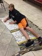 Boy laying on plastic bag mat for mat ministry