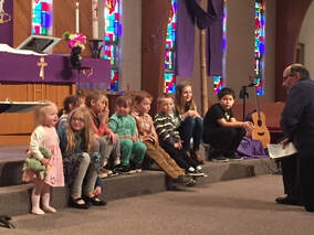Attentive children listening to Pastor during children's message