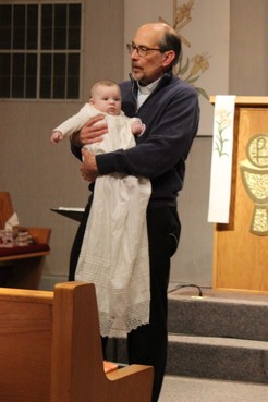 Pastor Rich holding baby after being baptized